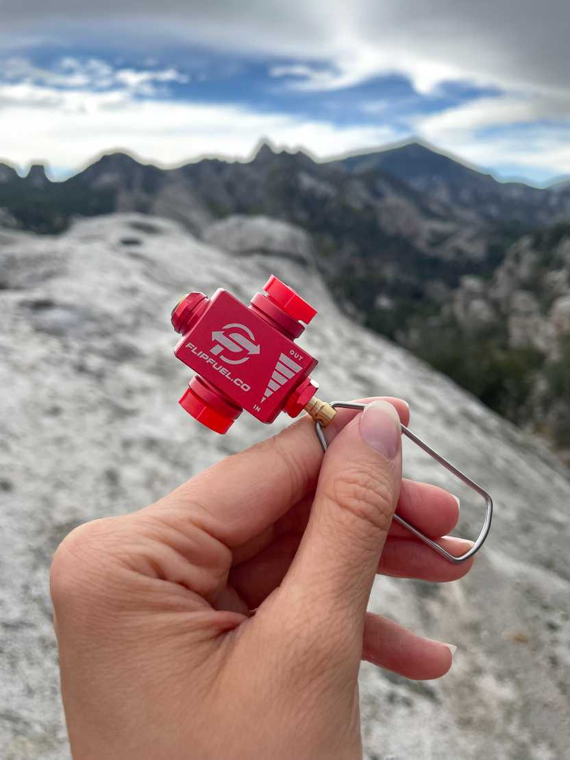 Holding up the Flip Fuel, a small, red device. Holding up the Flip Fuel, a small, red device.