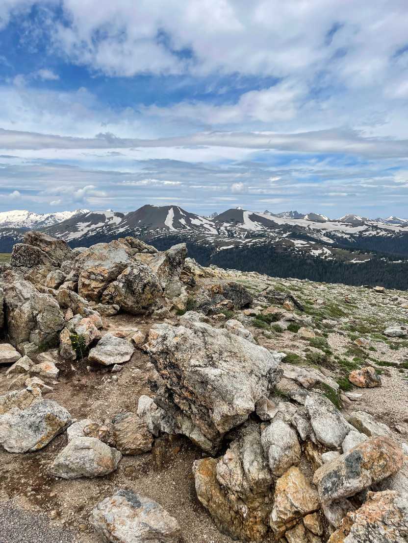 A view of alpine landscapes and mountains in the distance along Trail Ridge Road.