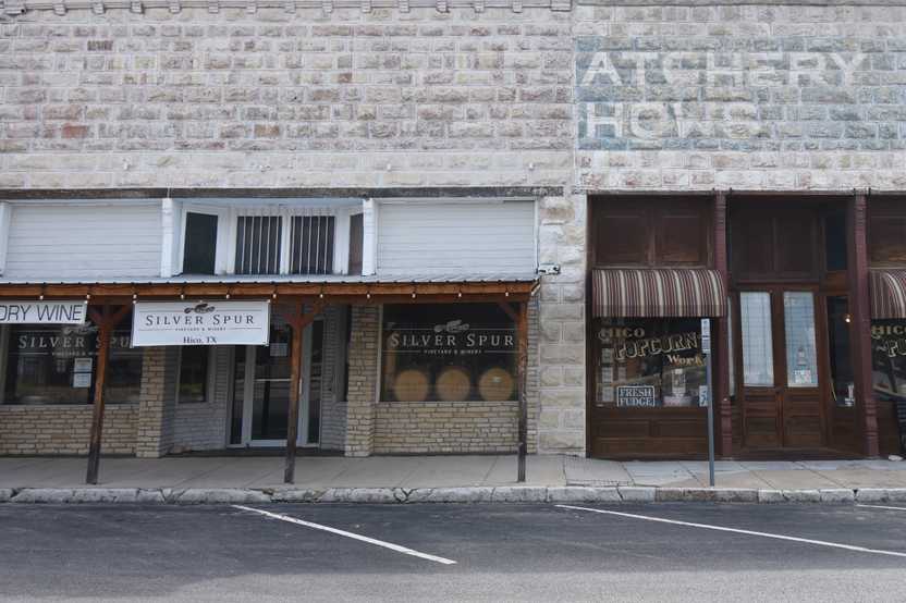 The exterior of Silver Spur Winery. You can see some barrels in the window.