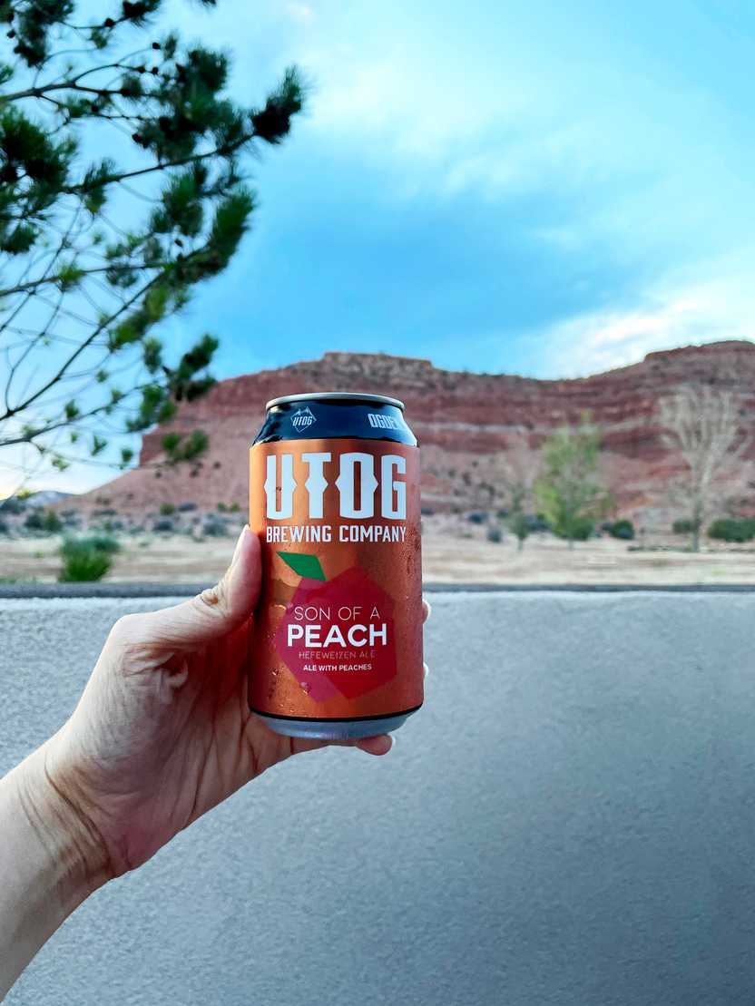 Holding up a local Utah beer with orange rocks in the background. Holding up a local Utah beer with orange rocks in the background.