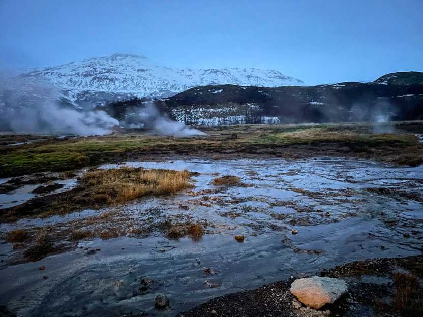 An area of water with steam coming up in various areas.
