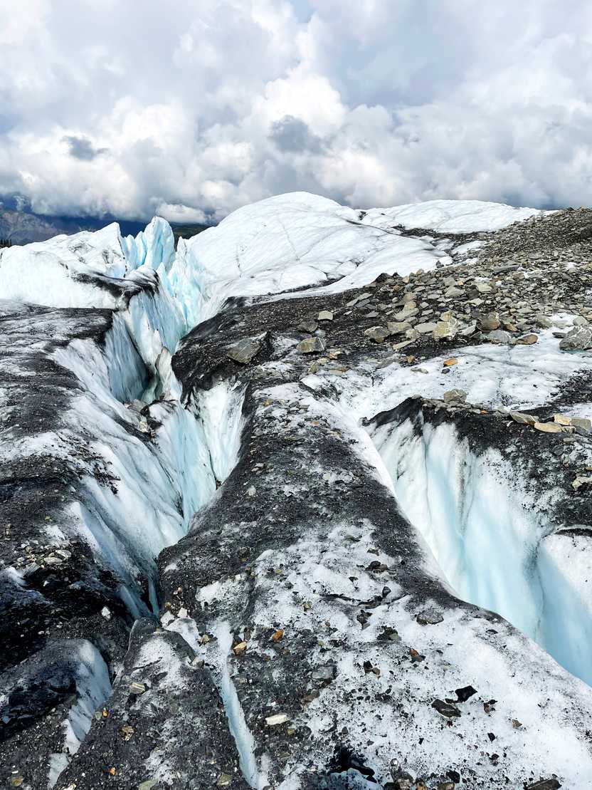 Walking on top of Matanuska Glacier with some large crevasses on either side.