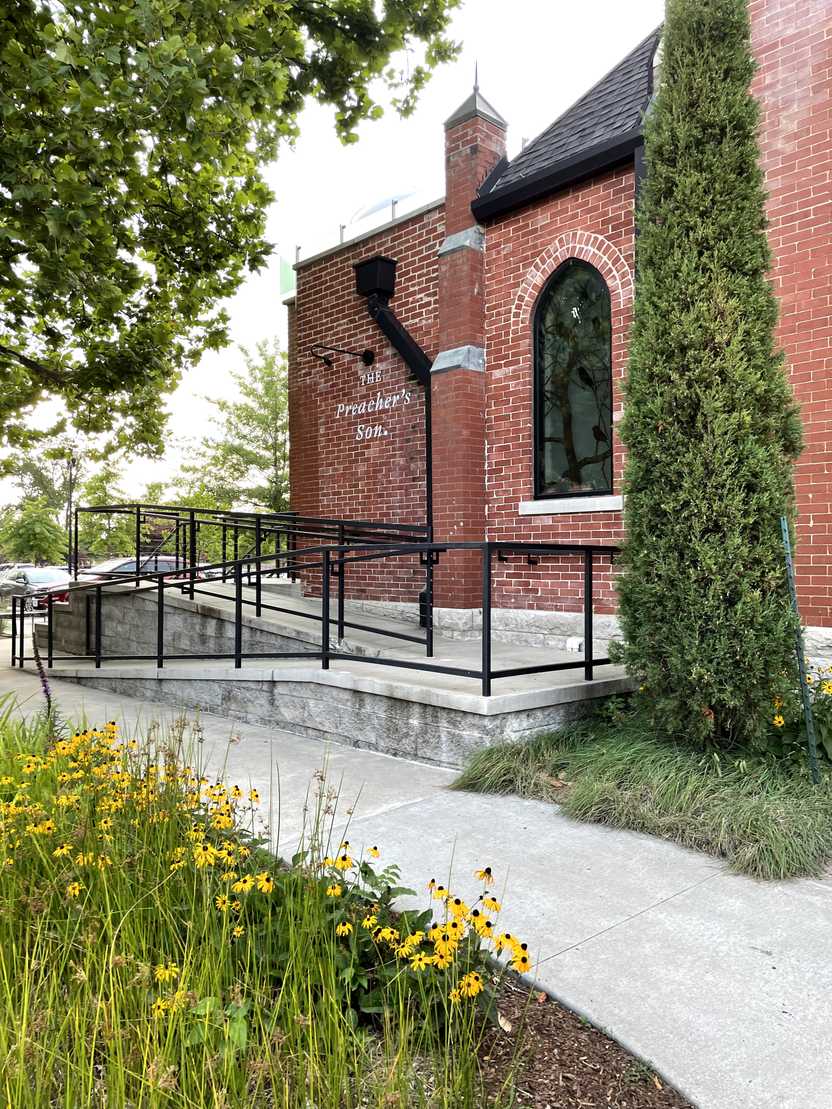 The exterior of The Preacher's Son, a brick building that is formerly a church.