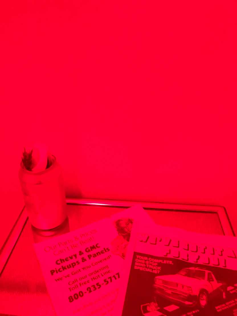 A wall covered in red light at the Little Brother Bar on Rainey Street.