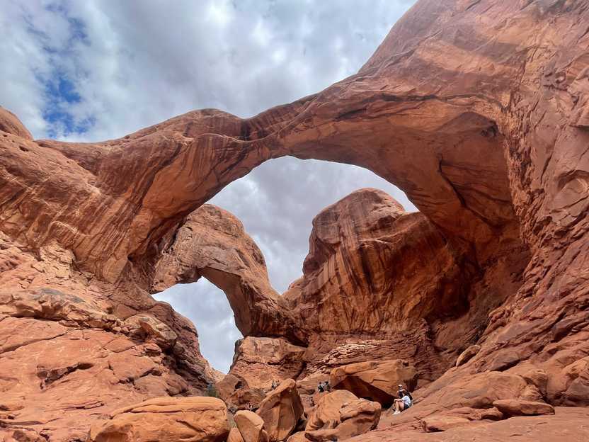 Looking up at two giant arches that seem to stem from the same point.
