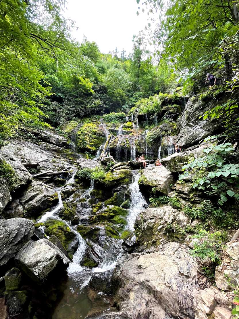 A view of Catawba Falls, where water trickles down a pile of rocks.