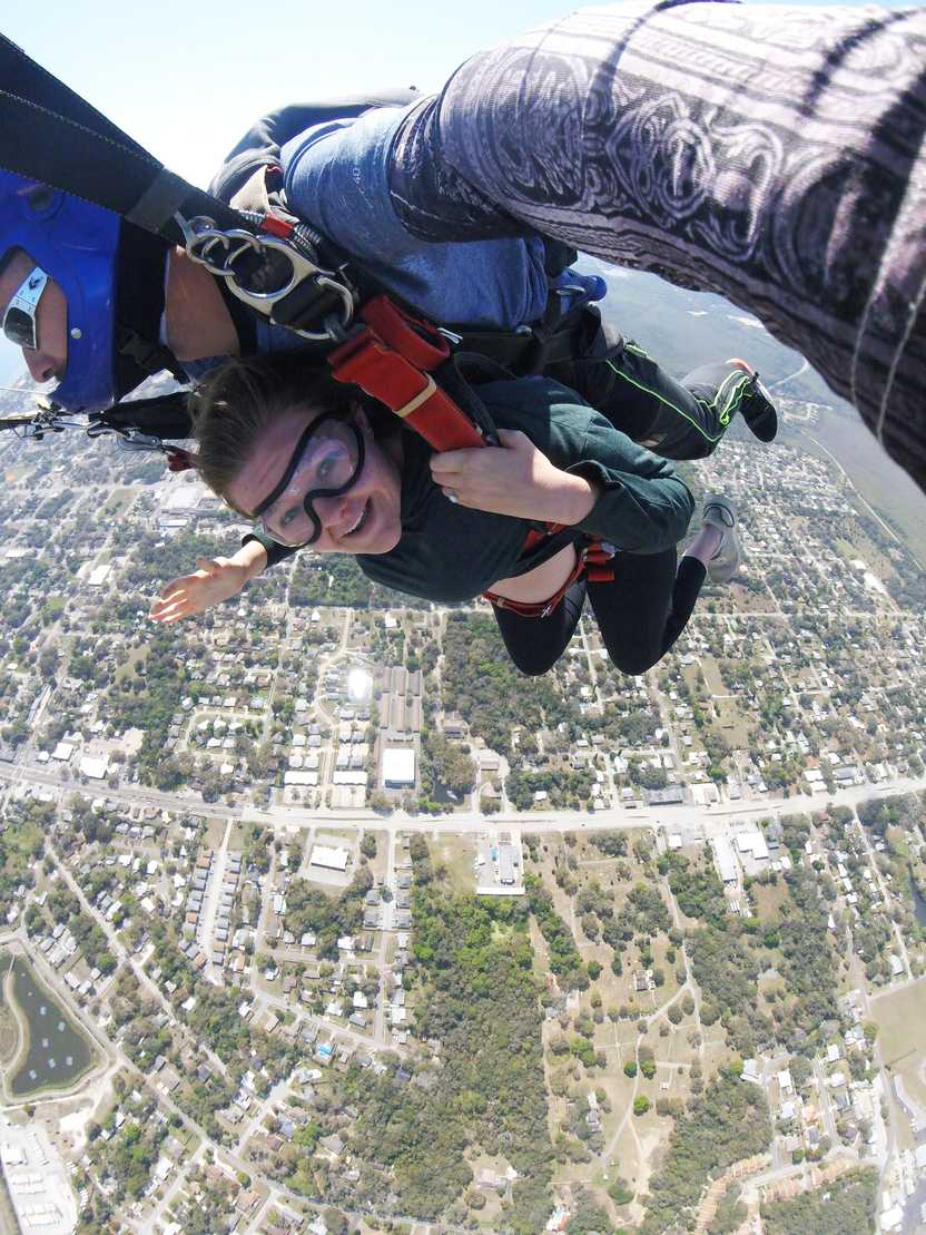Lydia looking at the camera, wearing googles while falling from the sky. Lydia looking at the camera, wearing googles while falling from the sky.