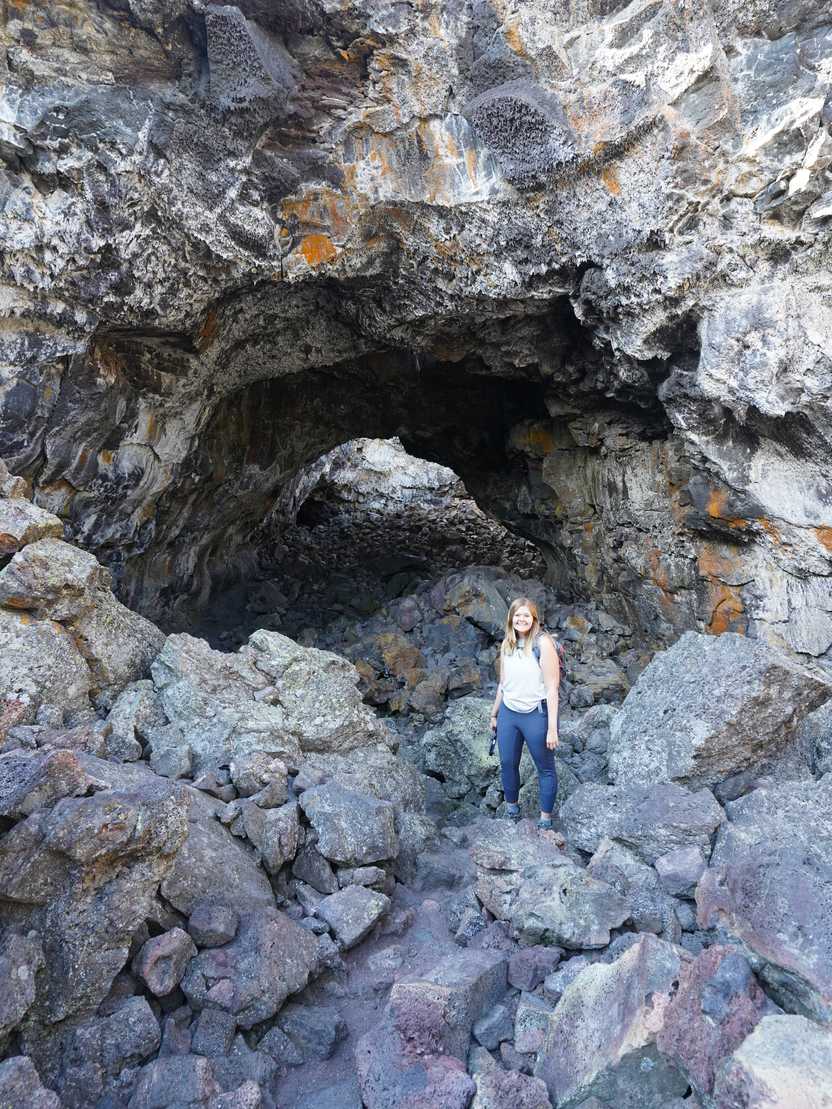 Lydia inside a large cave at Craters of the Moon. Lydia inside a large cave at Craters of the Moon.
