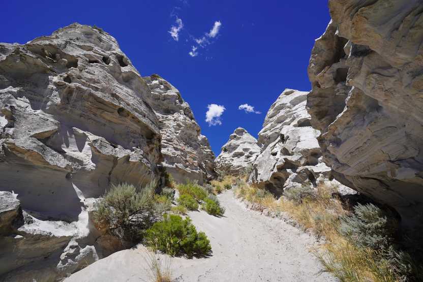 Several white rock towers forming a shape resembling a teepee