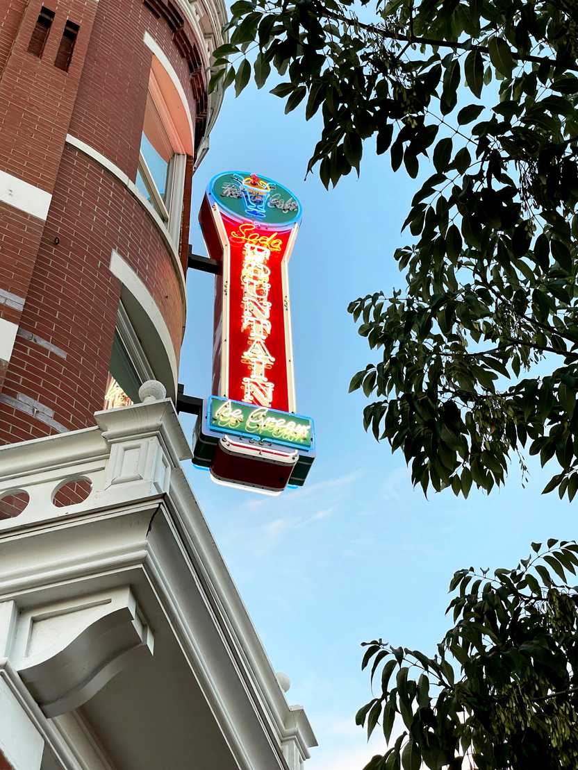 A neon sign for a Soda Fountain shop
