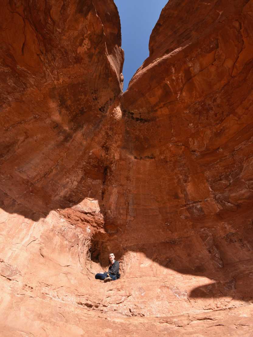 Joe sitting up in the back nook of Birthing Cave.