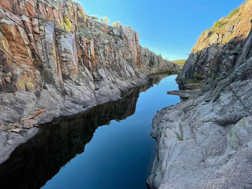 Walls of white-gray rocks on either side of a river in the Wichita Mountains.