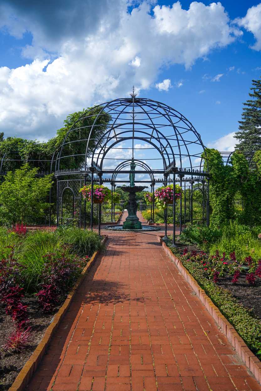 A structure and a fountain surrounded by flowers at Munsinger Gardens A structure and a fountain surrounded by flowers at Munsinger Gardens