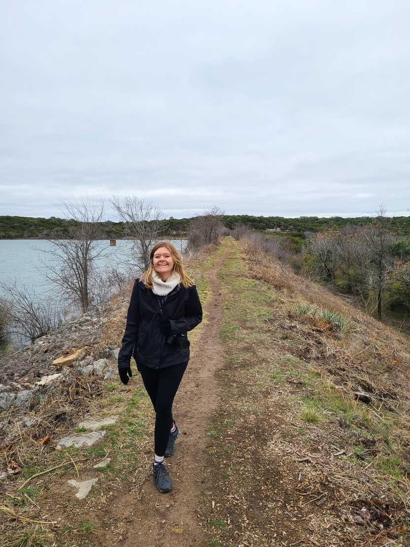 Lydia walking along a trail next to the lake in Cleburne State Park Lydia walking along a trail next to the lake in Cleburne State Park
