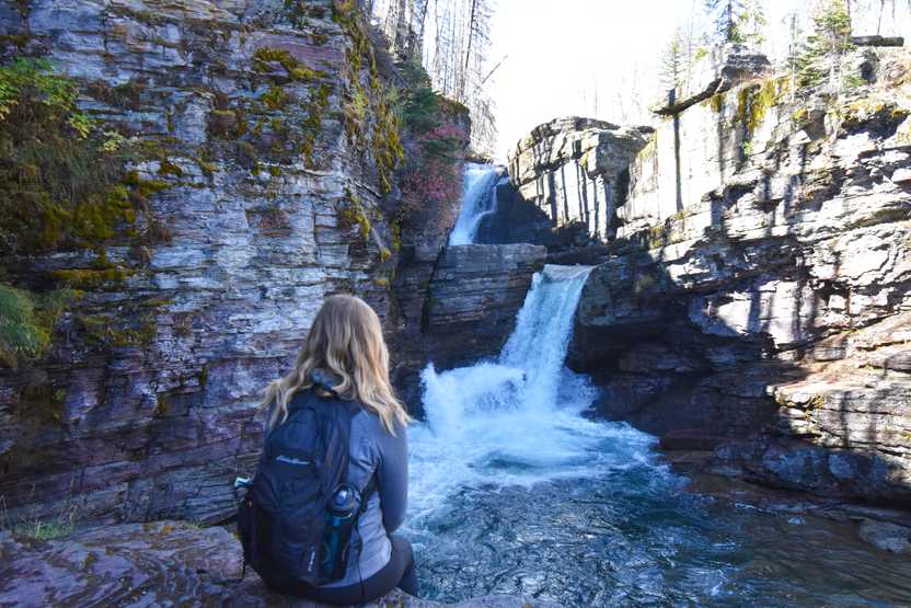 Lydia sitting in front of St Mary Falls.
