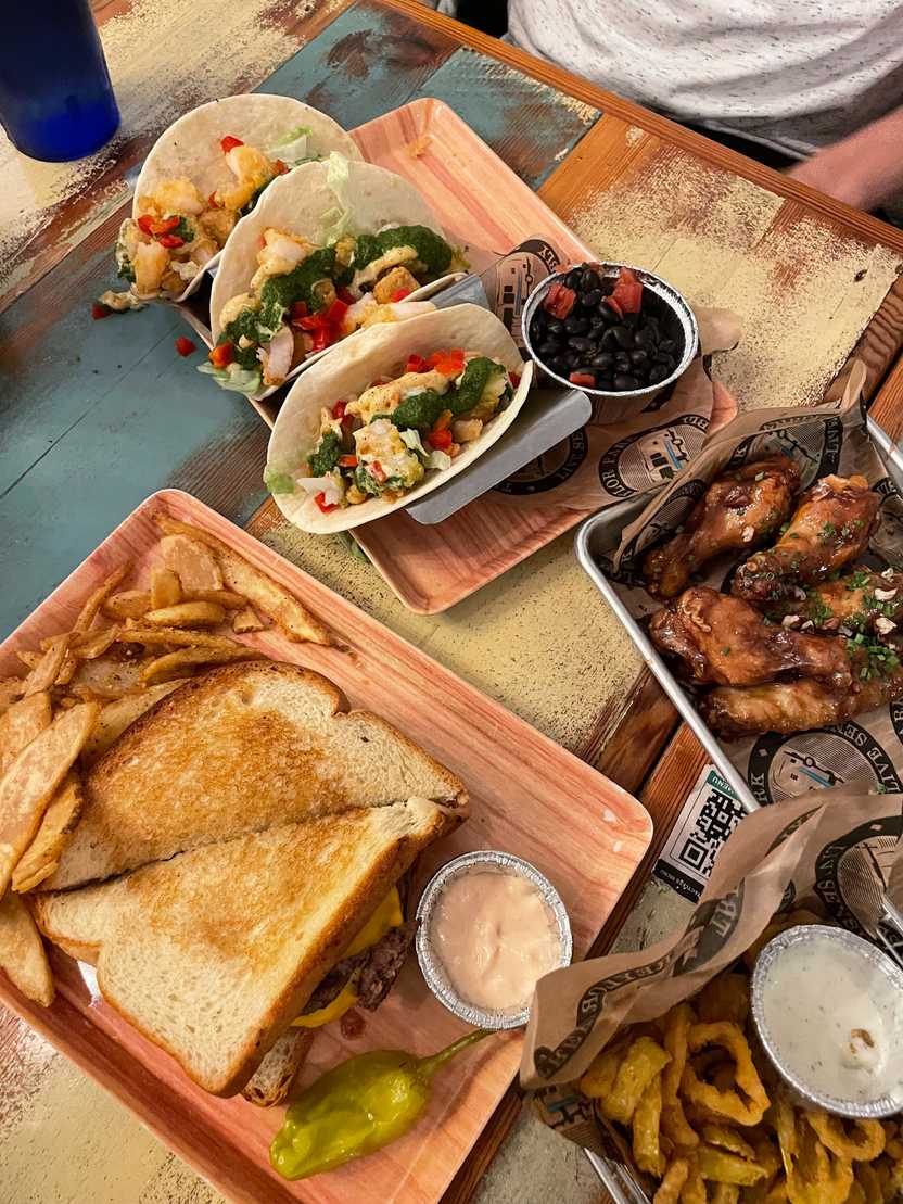 Looking at a grilled cheese, tacos and wings at Treylor Park